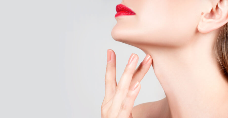 Woman with red lipstick touching neck