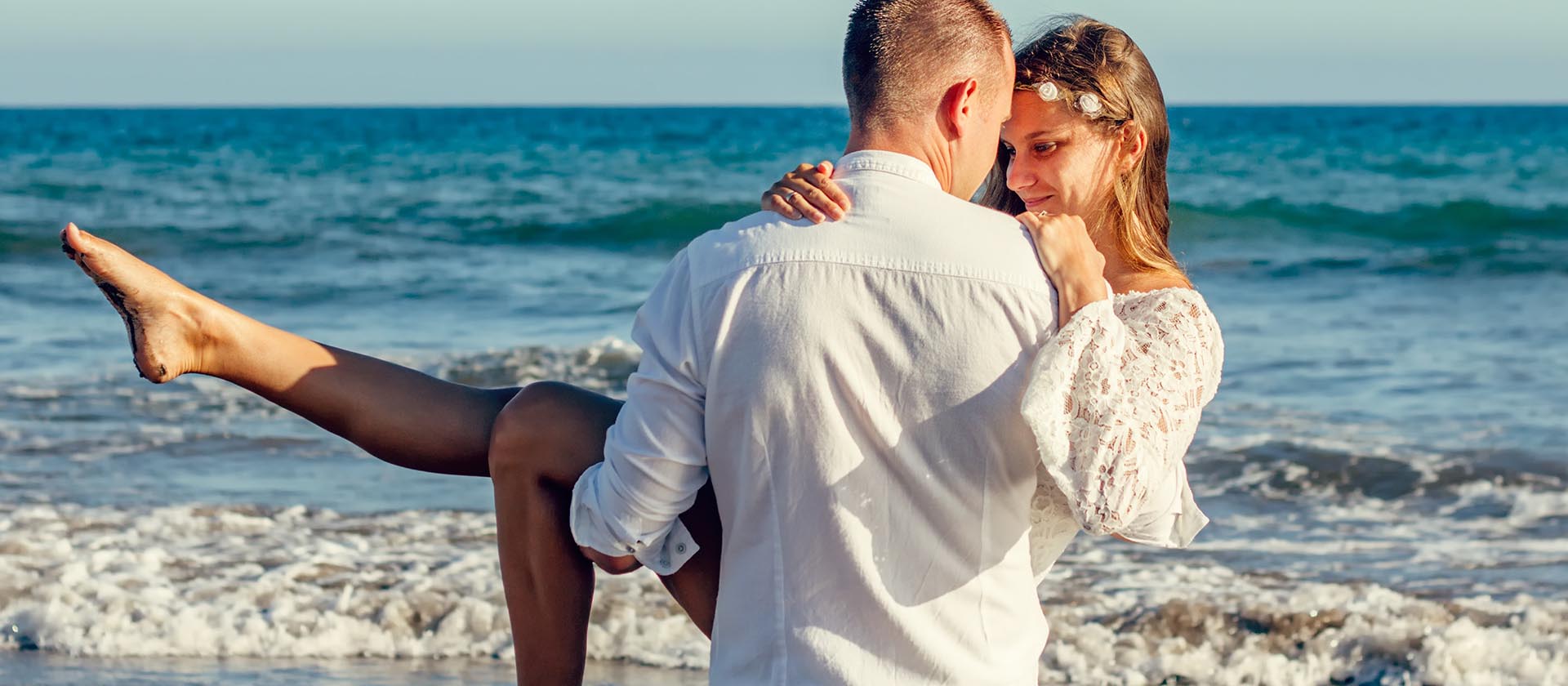 Man carrying woman at the beach