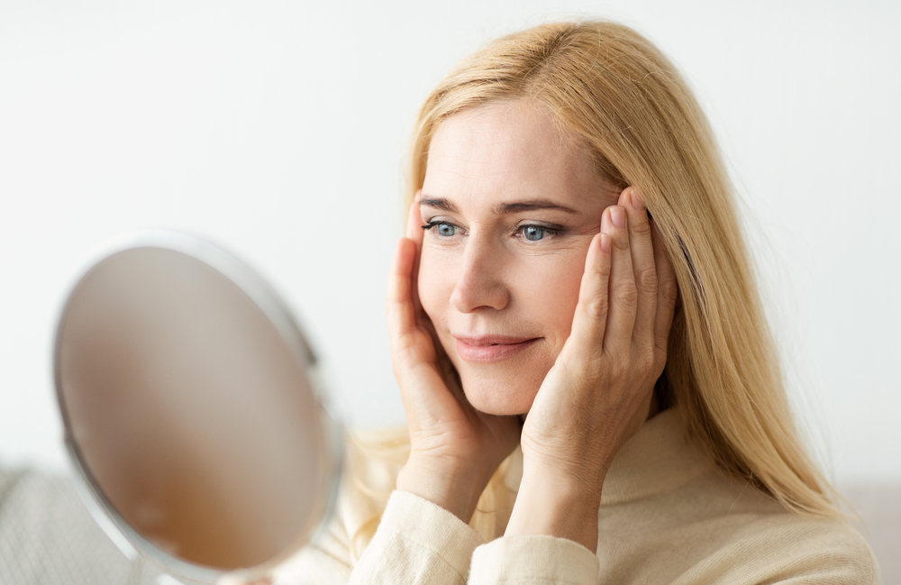 Woman looking at herself in the mirror