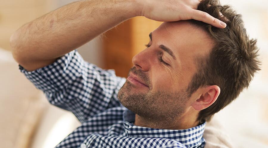 Man combing hair back with hands