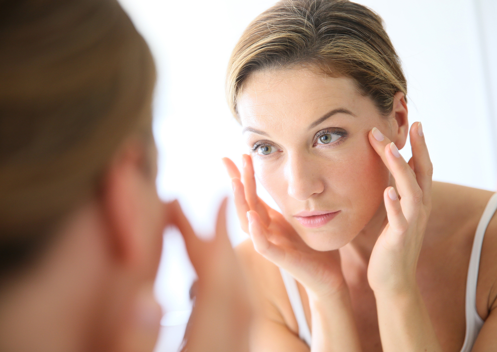 Woman looking at her self in the mirror