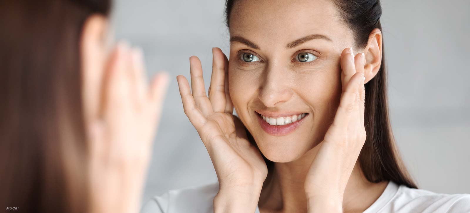 Woman looking at herself in the mirror