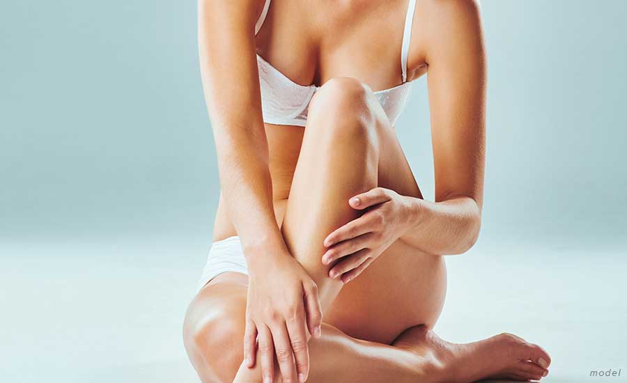 Woman sitting with her hands over her legs